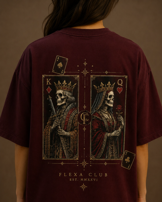 A person shown from the back wearing an oversized maroon drop shoulder T-shirt with a large graphic print of two crowned skull queens on playing card-style panels, plus the text 'FLEXA CLUB EST. MMXVI'.