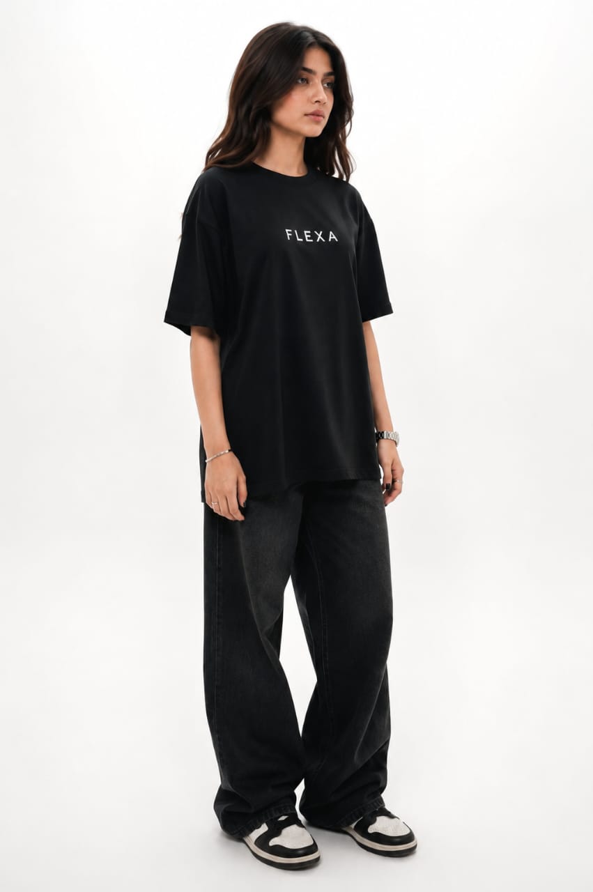 Person wearing a black 'FLEXA' t-shirt on a white background