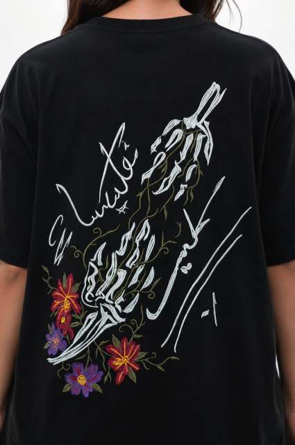 Black t-shirt with white skeleton design and colorful flowers on a white background