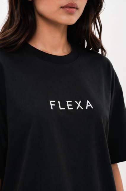 Person wearing a black t-shirt with 'FLEXA' logo on a white background