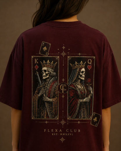 A person shown from the back wearing an oversized maroon drop shoulder T-shirt with a large graphic print of two crowned skull queens on playing card-style panels, plus the text 'FLEXA CLUB EST. MMXVI'.