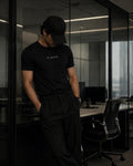 Person wearing a black 'FLEXA' t-shirt in an office setting