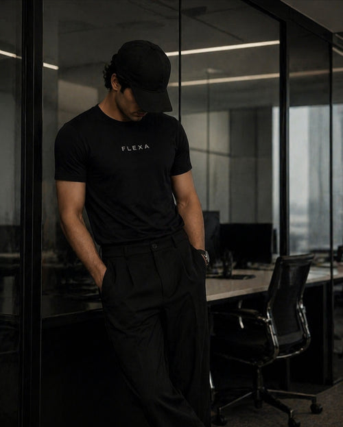 Person wearing a black 'FLEXA' t-shirt in an office setting